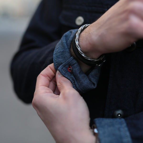 Bracelet torsadé large au poignet d'un homme